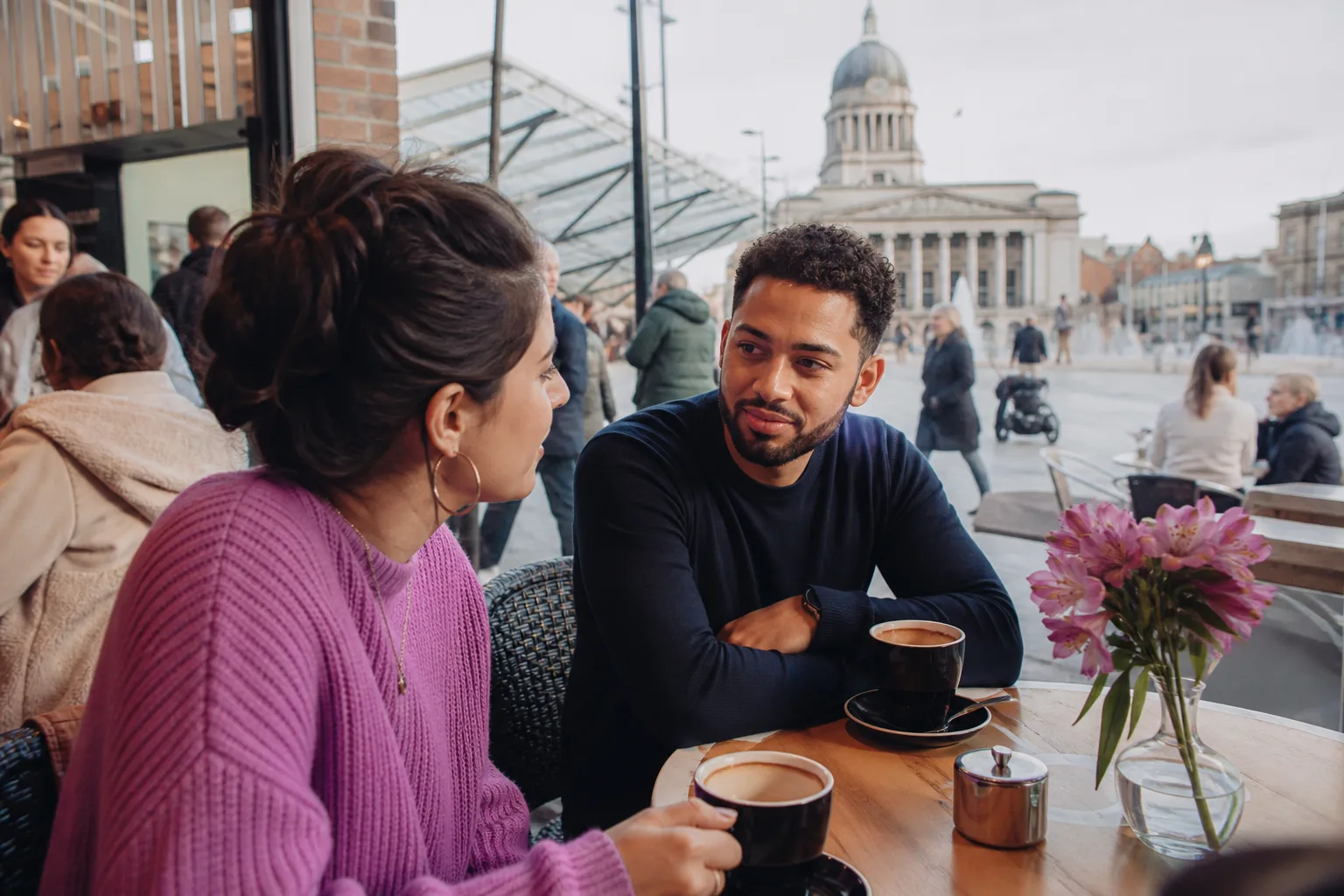 Two people talking over coffee at a café in Nottingham city centre